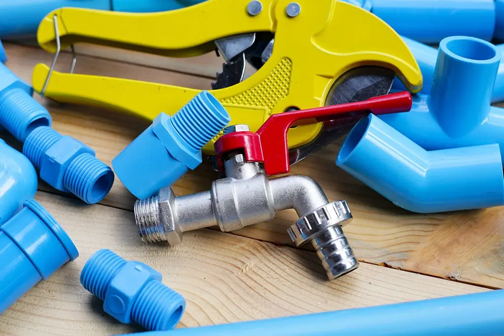 Blue PVC pipe pieces adn a PVC cutting tool