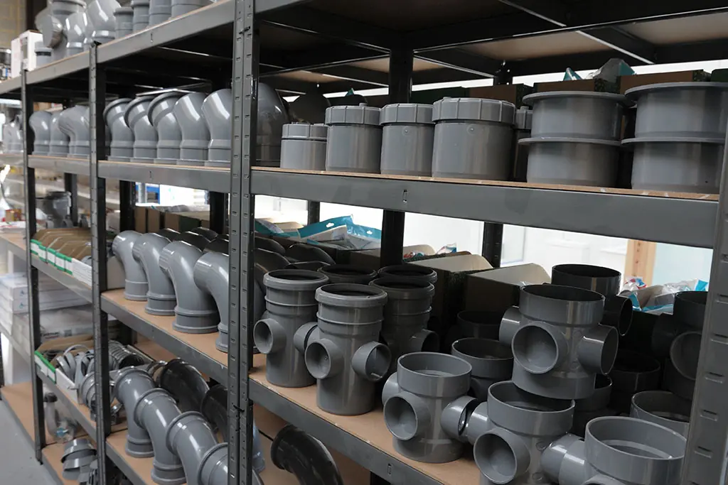 Grey PVC elbows and connectors in a Plumbing Supply Warehouse